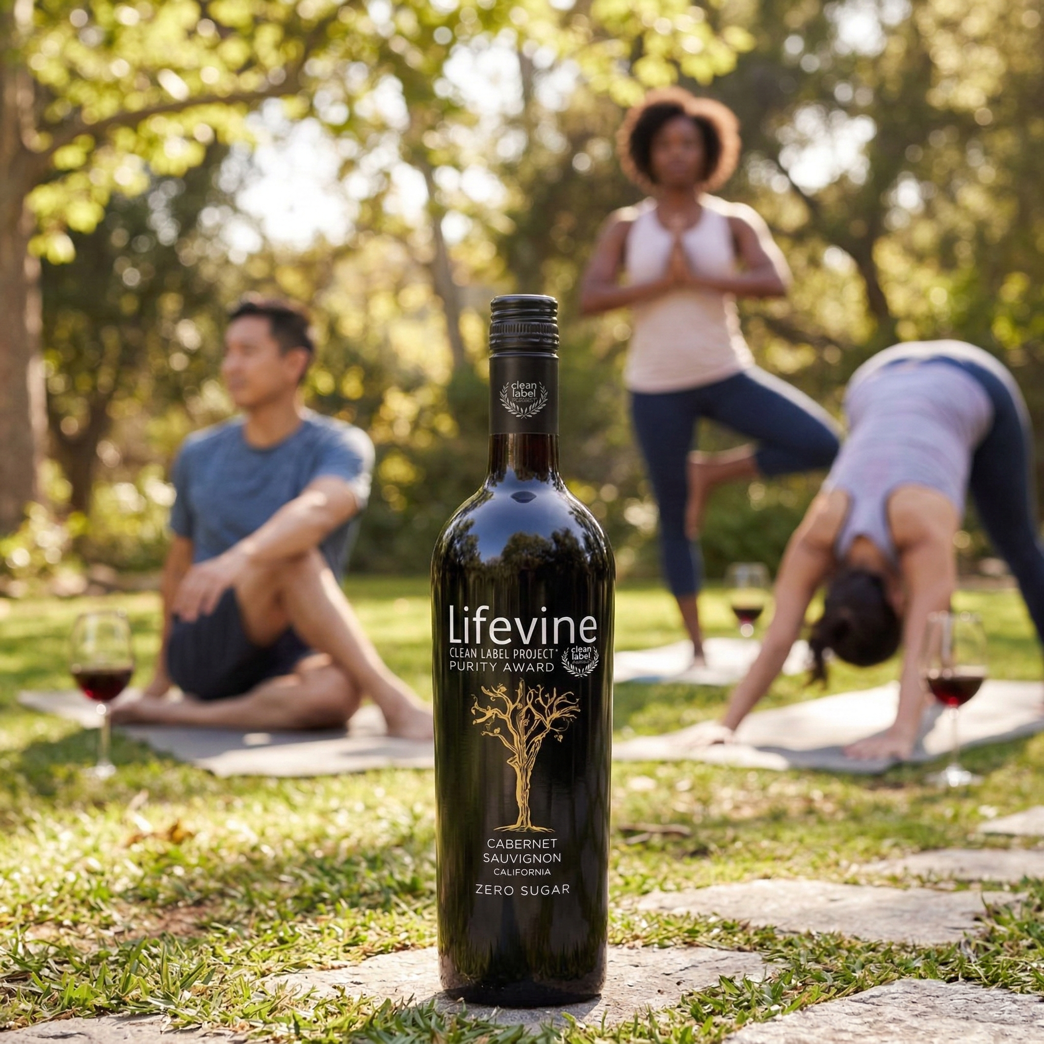 Lifevine zero sugar wine bottle with people practicing yoga in a park